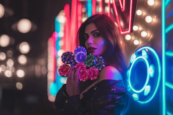 A glamorous woman holding casino chips in a neon-lit environment, representing the premium online casino atmosphere of CT44.
