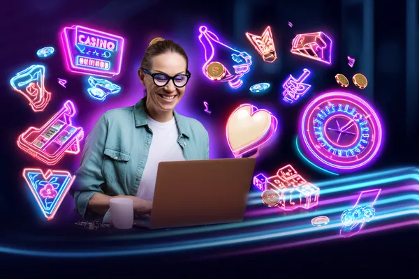 A woman smiling while playing online games on her laptop, surrounded by neon casino elements, showcasing CT44’s diverse game collection.