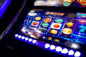 A vibrant slot machine bursting with lights and winning icons, highlighting the thrill of CT44’s top-rated slot titles.